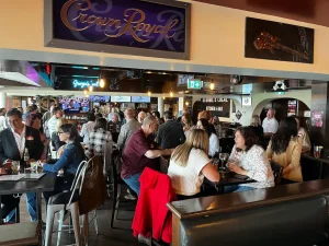 A crowded and lively singles mixer for people over 50 at Georgie's Local in New Westminster, featuring social icebreakers and local networking.