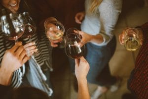 Group of people clinking wine glasses together at a Metro Vancouver singles social event