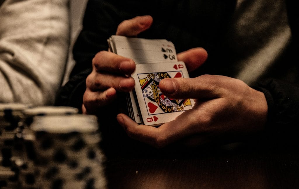 Dealer shuffling a deck of playing cards at a Monday night Texas Hold'em poker game in Delta BC