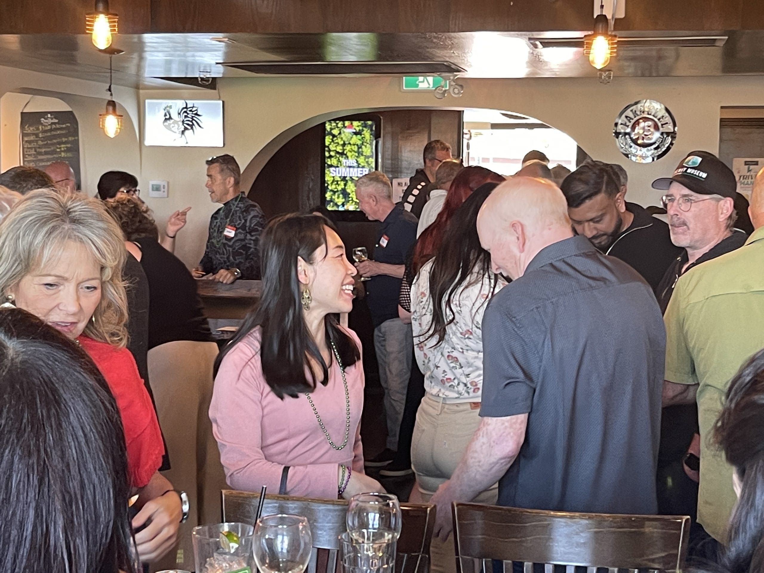Guests laughing and mingling at a singles mixer New Westminster event at Georgie's Local Kitchen & Bar