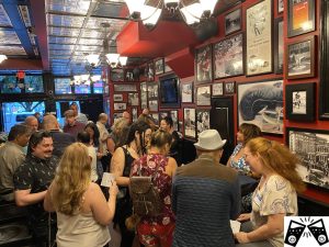 Guests mingling and filling in bingo cards at a social event to meet new friends over 45 at The Pint in Vancouver
